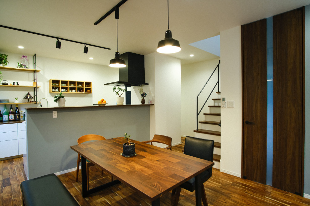 Example of a mid-sized minimalist formal and open concept dark wood floor, brown floor, wallpaper ceiling and wallpaper living room design in Other with white walls, no fireplace and a wall-mounted tv