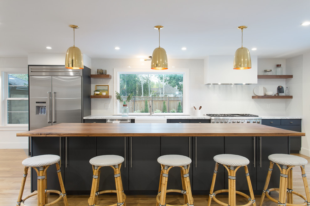 Inspiration for a mid-sized contemporary galley eat-in kitchen in Salt Lake City with a farmhouse sink, flat-panel cabinets, blue cabinets, quartz benchtops, white splashback, ceramic splashback, stainless steel appliances, light hardwood floors and with island.