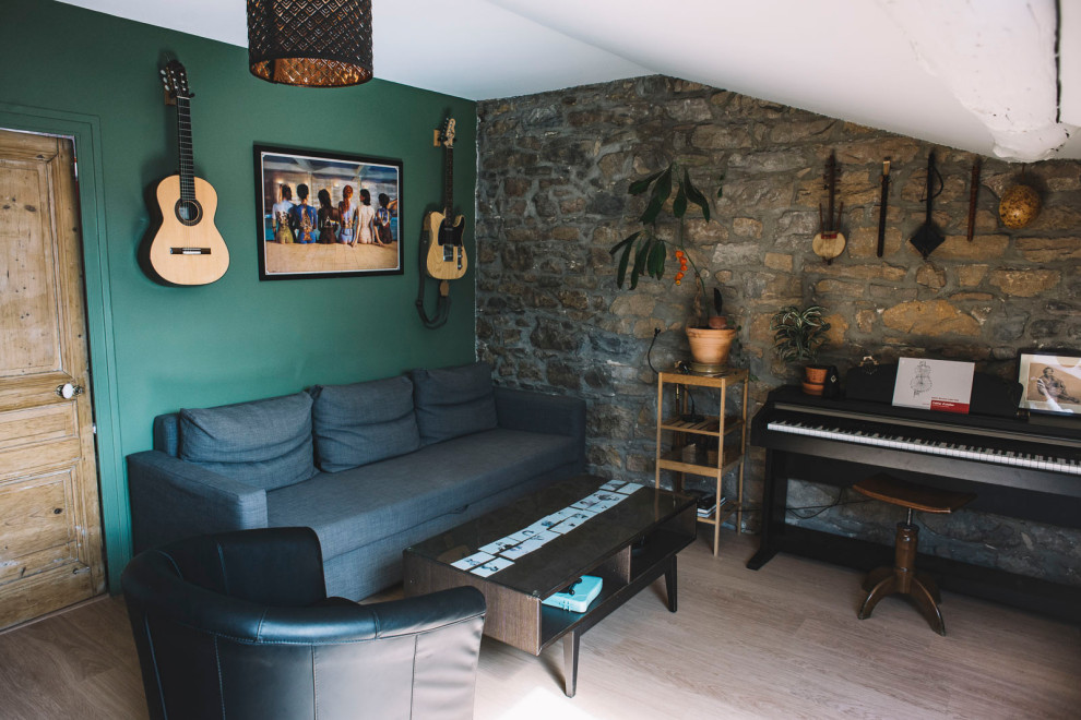 На фото: гостиная комната с зелеными стенами и кирпичными стенами