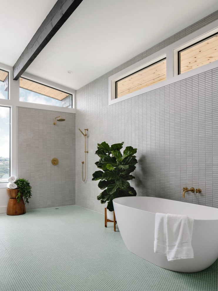 Photo of a mid-sized midcentury master wet room bathroom in Austin with a freestanding tub, an undermount sink, a single vanity and a built-in vanity.