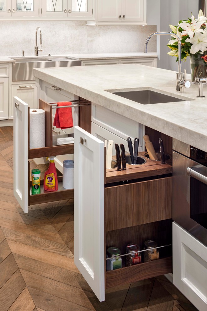 Inspiration for a transitional medium tone wood floor kitchen remodel in Denver with an undermount sink, shaker cabinets, white cabinets, white backsplash, stainless steel appliances and two islands