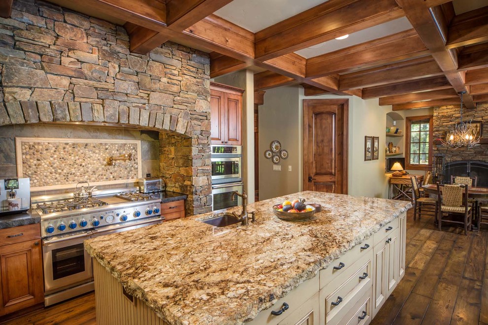 Inspiration for a large rustic u-shaped medium tone wood floor eat-in kitchen remodel with an undermount sink, beaded inset cabinets, medium tone wood cabinets, granite countertops, gray backsplash, stone tile backsplash, stainless steel appliances and an island
