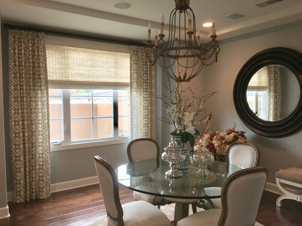 Inspiration for a mid-sized transitional medium tone wood floor and brown floor enclosed dining room remodel in Orange County with gray walls and no fireplace