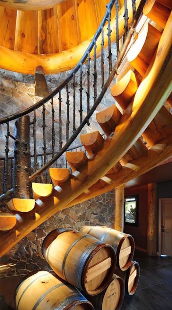 Large mountain style wooden curved open and metal railing staircase photo in Seattle