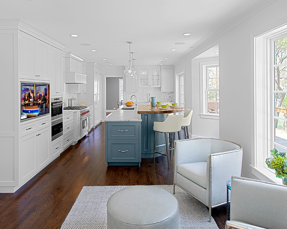 Mid-sized transitional u-shaped dark wood floor and brown floor kitchen photo in Chicago with recessed-panel cabinets, stone tile backsplash, an island, white cabinets, quartz countertops, white backsplash, stainless steel appliances and gray countertops
