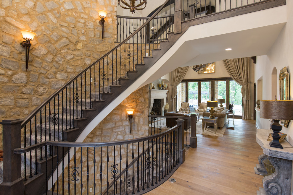 Design ideas for a traditional wood curved staircase in Kansas City with metal railing and wood risers.