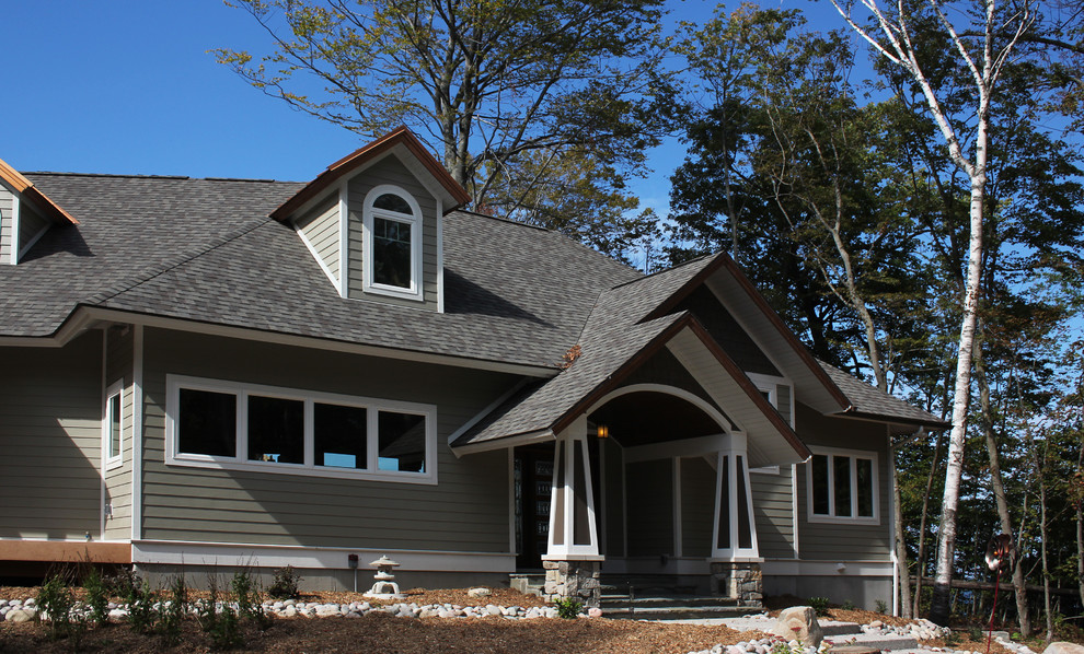 Mid-sized traditional one-storey beige exterior in Other with concrete fiberboard siding and a gable roof.