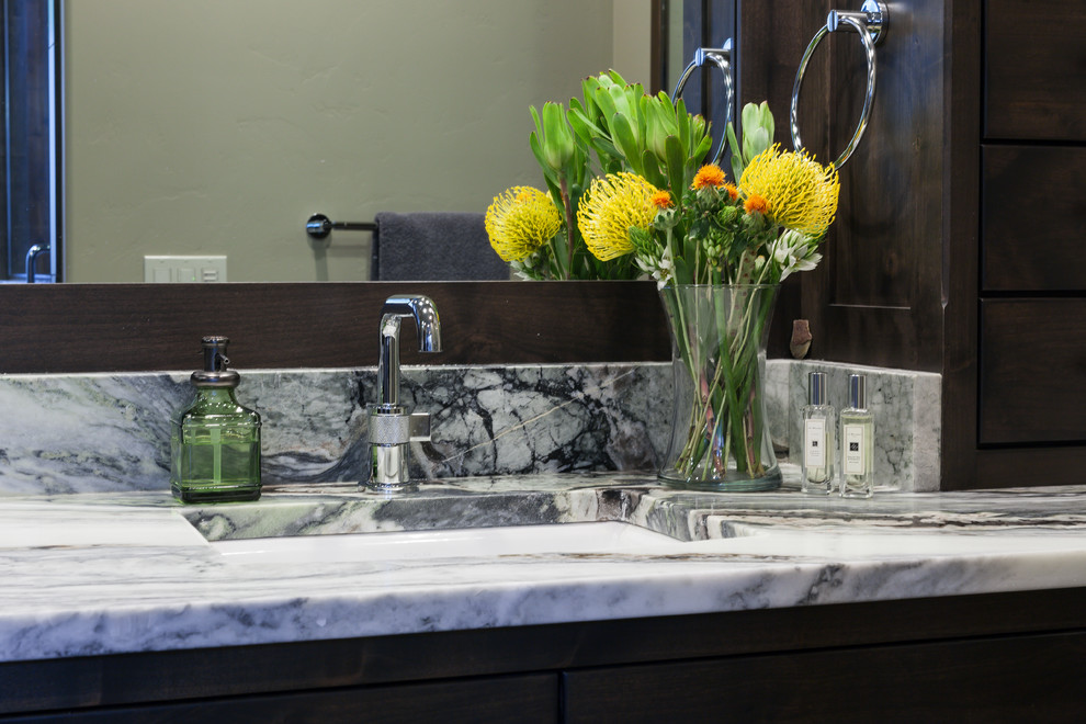 Example of a large transitional master bathroom design with shaker cabinets, brown cabinets, an undermount sink, quartzite countertops and multicolored countertops