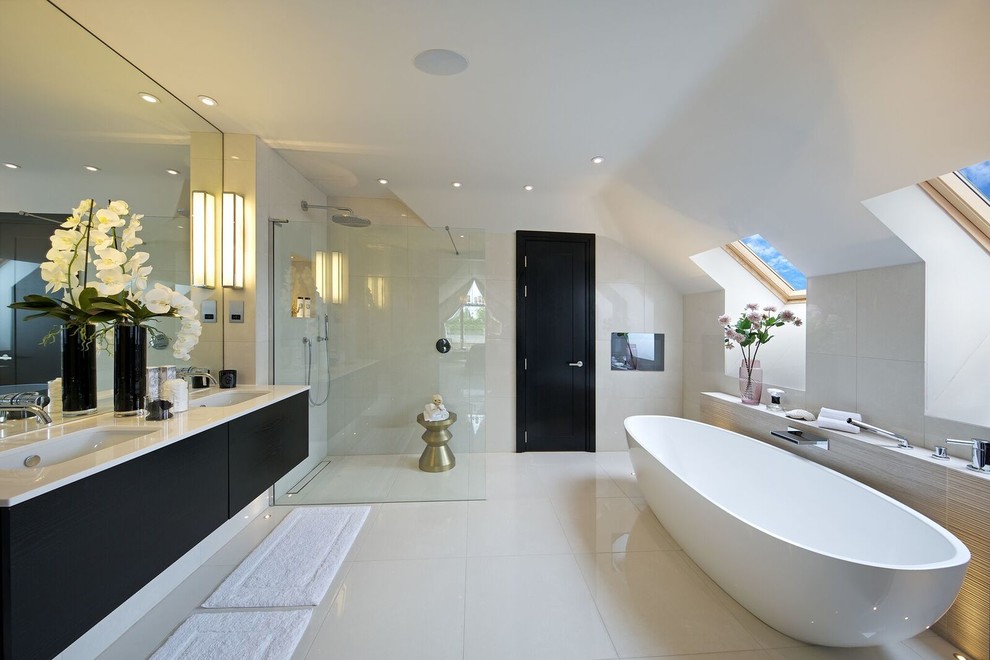 This is an example of a contemporary bathroom in Hertfordshire with flat-panel cabinets, a curbless shower, an undermount sink, dark wood cabinets, an alcove tub, white tile, porcelain tile, white walls, porcelain floors, engineered quartz benchtops and an open shower.