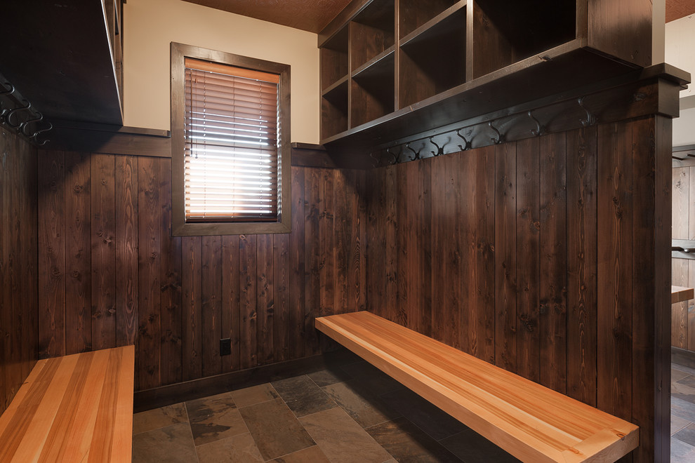 Example of a mountain style slate floor and multicolored floor mudroom design with beige walls