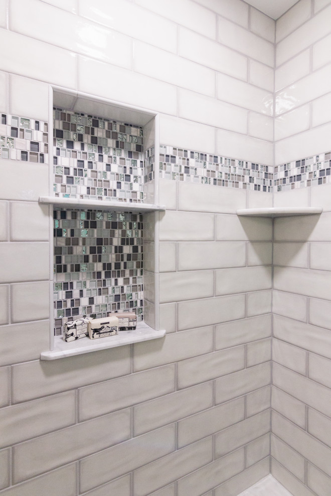 Mid-sized transitional master green tile and ceramic tile porcelain tile, white floor and double-sink sliding shower door photo with shaker cabinets, gray cabinets, a two-piece toilet, an undermount sink, quartz countertops, white countertops, a niche and a built-in vanity