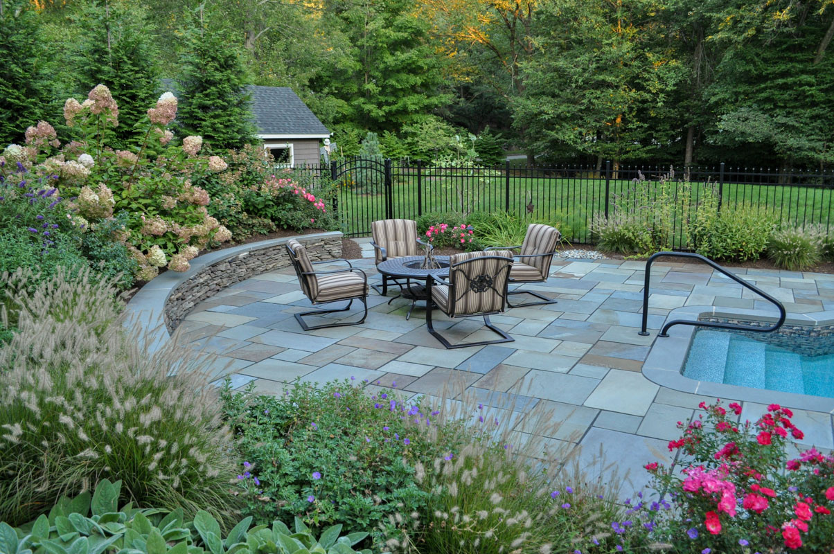 Flagstone Patio with low sitting wall at this pool side property. Landscaping by Peter Atkins and Associates;,LLC
