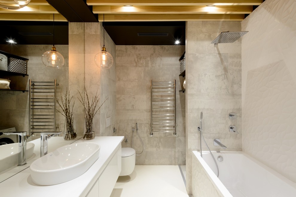 Inspiration for a small industrial master bathroom in Novosibirsk with flat-panel cabinets, white cabinets, an alcove tub, a shower/bathtub combo, a wall-mount toilet, white tile, porcelain tile, grey walls, a drop-in sink, solid surface benchtops and white floor.