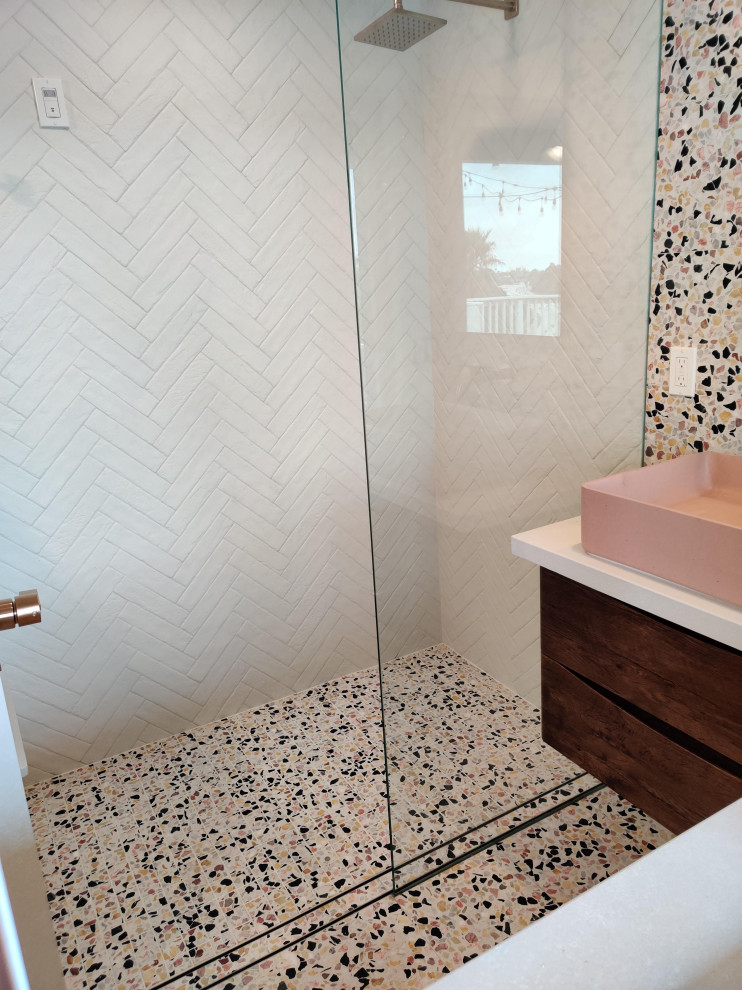 Design ideas for a small contemporary master bathroom in San Diego with medium wood cabinets, a curbless shower, a wall-mount toilet, white tile, porcelain tile, white walls, terrazzo floors, a vessel sink, engineered quartz benchtops, multi-coloured floor, an open shower and beige benchtops.