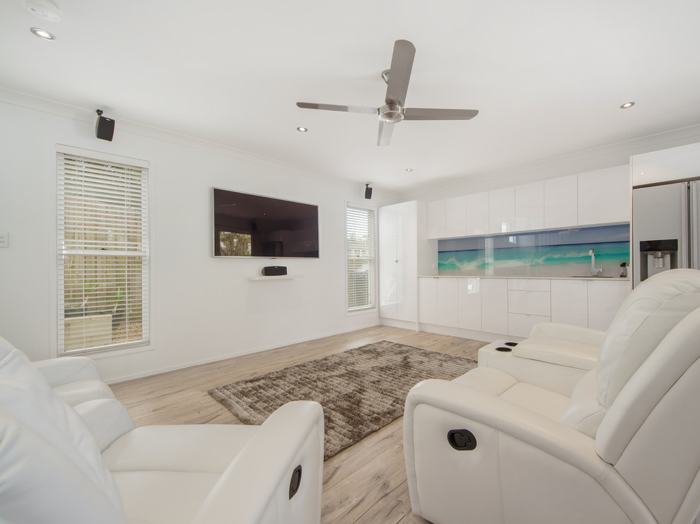 Mid-sized contemporary open concept living room in Gold Coast - Tweed with white walls, light hardwood floors and a wall-mounted tv.
