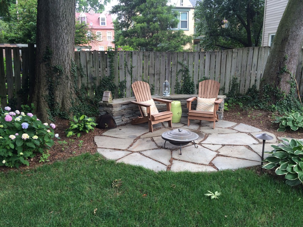 Design ideas for a large traditional backyard patio in Philadelphia with a fire feature, natural stone pavers and no cover.