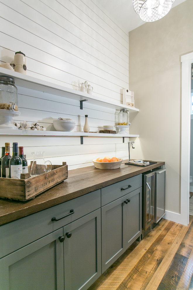 Inspiration for a country single-wall home bar in Austin with shaker cabinets, grey cabinets, wood benchtops, white splashback and timber splashback.