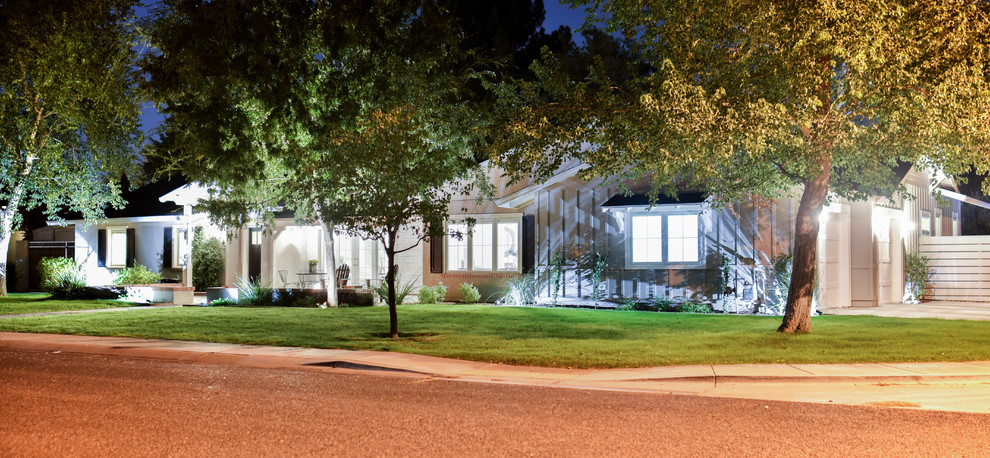 This is an example of a mid-sized traditional one-storey beige house exterior in Phoenix with mixed siding, a hip roof and a shingle roof.