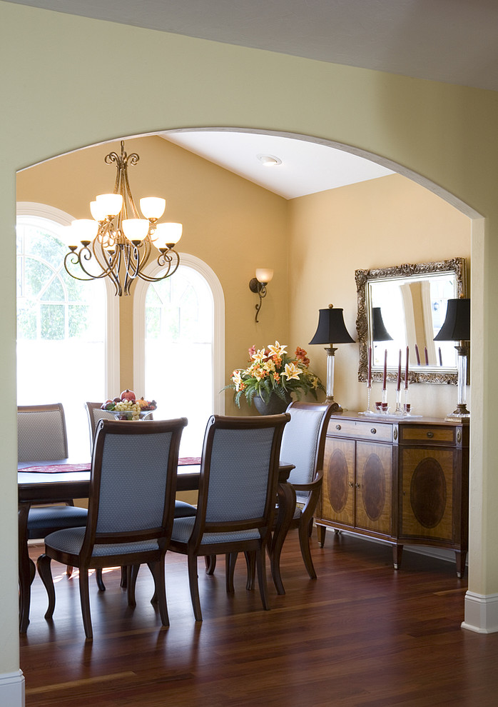 Inspiration for a mediterranean dining room in Seattle with dark hardwood floors and beige walls.