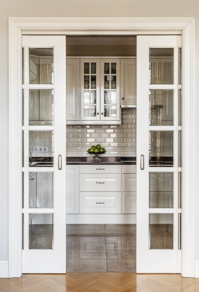 Inspiration for a small traditional l-shaped separate kitchen in Other with raised-panel cabinets, white cabinets, quartz benchtops, ceramic splashback, porcelain floors, white splashback, no island and beige floor.