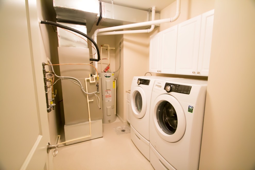 Small traditional single-wall dedicated laundry room in Minneapolis with white cabinets, laminate benchtops, beige walls, linoleum floors, a side-by-side washer and dryer and recessed-panel cabinets.