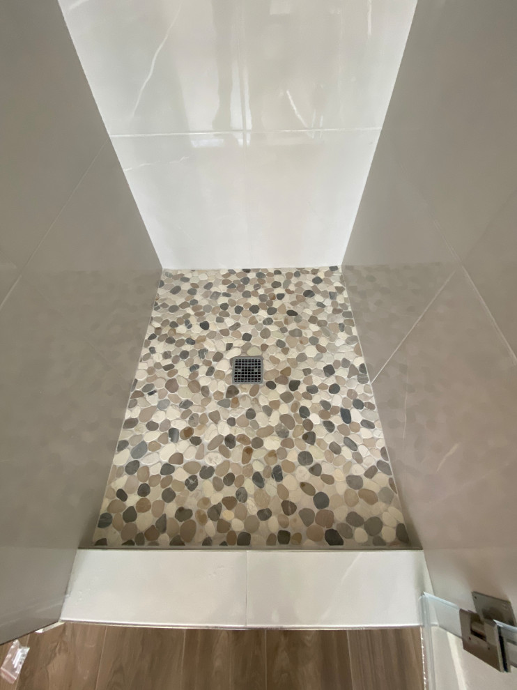 This is an example of a mid-sized contemporary master bathroom in San Francisco with shaker cabinets, dark wood cabinets, a freestanding tub, an alcove shower, a one-piece toilet, beige tile, porcelain tile, beige walls, wood-look tile, an undermount sink, engineered quartz benchtops, brown floor, a hinged shower door, multi-coloured benchtops, a double vanity and a built-in vanity.
