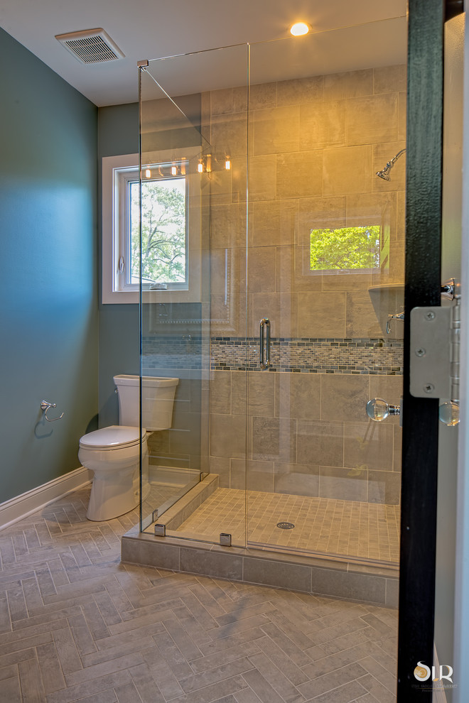 Corner shower - transitional 3/4 dark wood floor and beige floor corner shower idea with flat-panel cabinets, light wood cabinets, gray walls and a hinged shower door