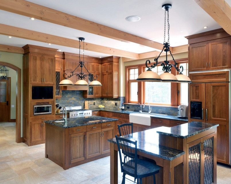 Large mountain style galley dark wood floor open concept kitchen photo in Boston with an undermount sink, shaker cabinets, white cabinets, granite countertops, stainless steel appliances and an island