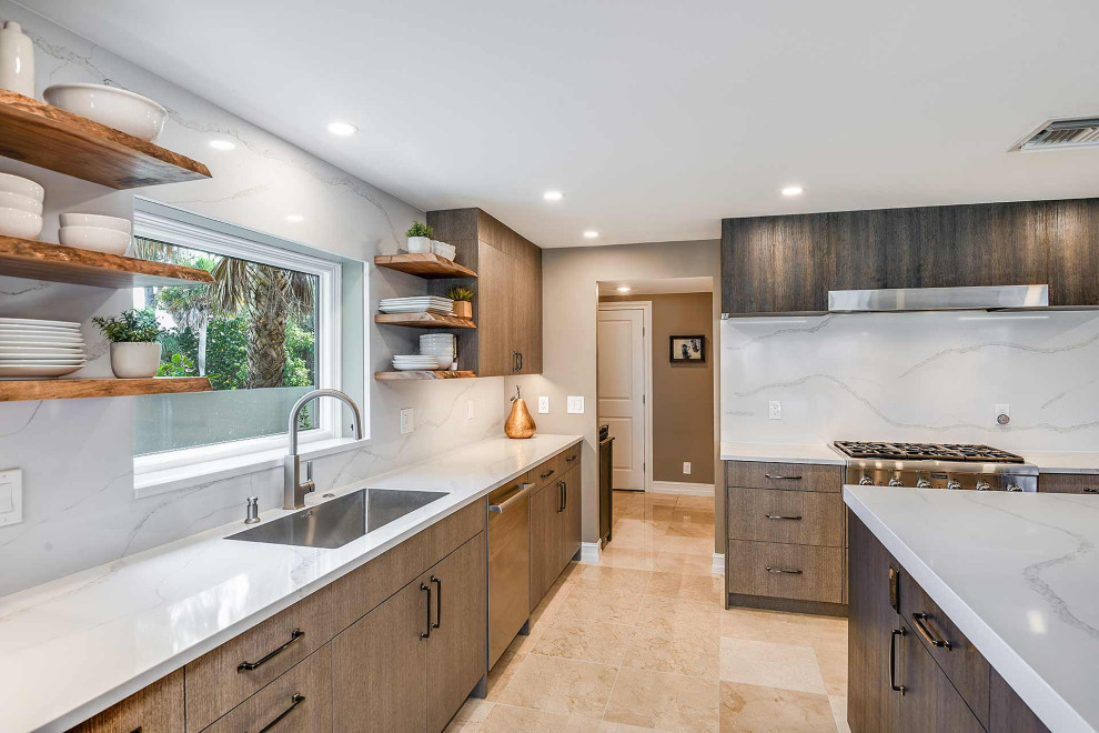 This is an example of an expansive modern u-shaped eat-in kitchen in Tampa with an undermount sink, flat-panel cabinets, brown cabinets, quartz benchtops, white splashback, engineered quartz splashback, stainless steel appliances, with island, beige floor and white benchtop.