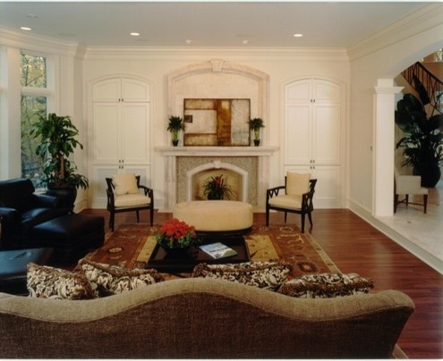 Photo of an expansive traditional formal enclosed living room in Chicago with white walls, dark hardwood floors, a standard fireplace, a stone fireplace surround and a concealed tv.
