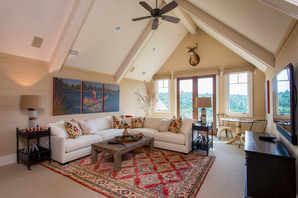 Mountain style carpeted family room photo with beige walls and a wall-mounted tv