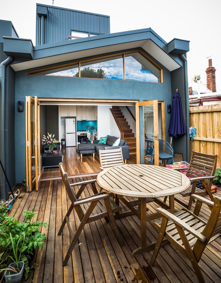 This is an example of a small transitional backyard deck in Melbourne.