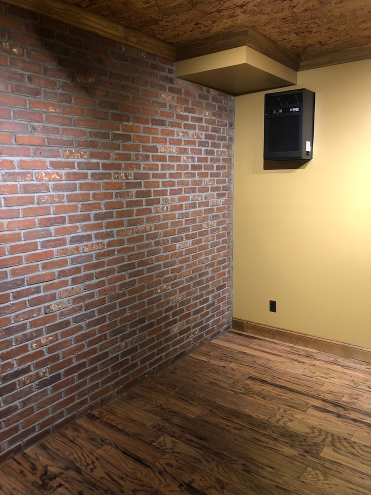 Example of a mid-sized mountain style laminate floor and brown floor wine cellar design with display racks