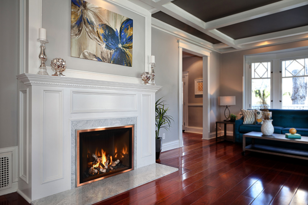Inspiration for a large transitional formal enclosed living room in Cedar Rapids with grey walls, dark hardwood floors, a standard fireplace, a wood fireplace surround, no tv and brown floor.