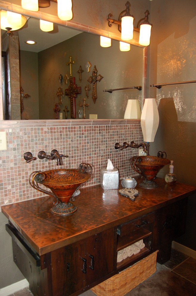 This is an example of a bathroom in Austin with a vessel sink, furniture-like cabinets, dark wood cabinets, copper benchtops, a shower/bathtub combo, a one-piece toilet and grey walls.