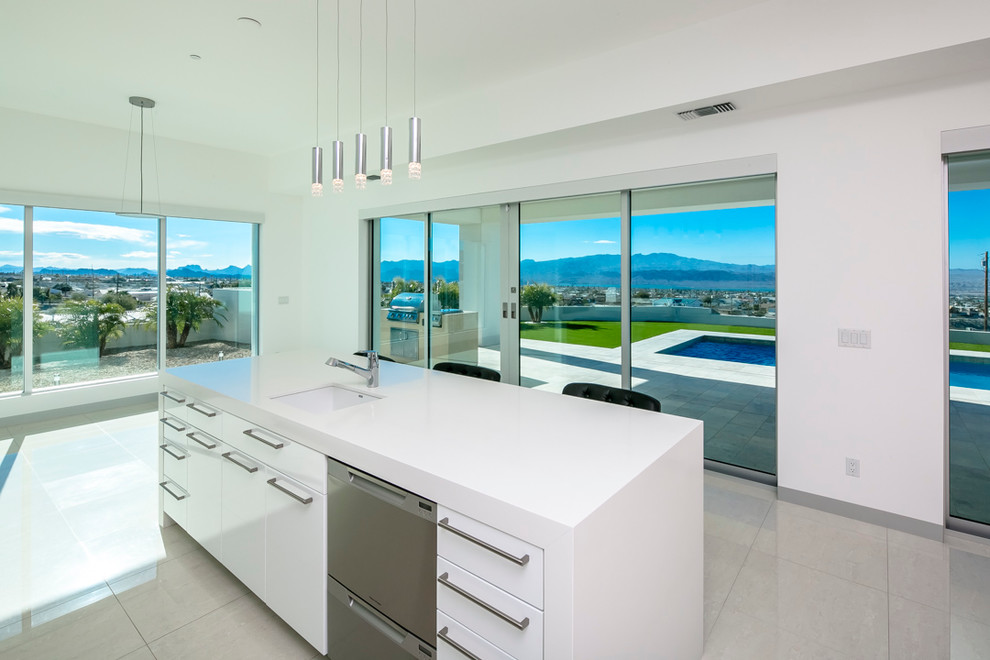 Inspiration for a mid-sized contemporary u-shaped eat-in kitchen in Phoenix with an undermount sink, flat-panel cabinets, white cabinets, quartzite benchtops, blue splashback, glass tile splashback, stainless steel appliances, marble floors, with island and grey floor.