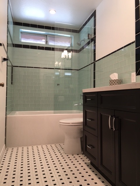 Design ideas for a mid-sized contemporary bathroom in Los Angeles with shaker cabinets, dark wood cabinets, a shower/bathtub combo, a one-piece toilet, multi-coloured tile, white walls and an undermount sink.