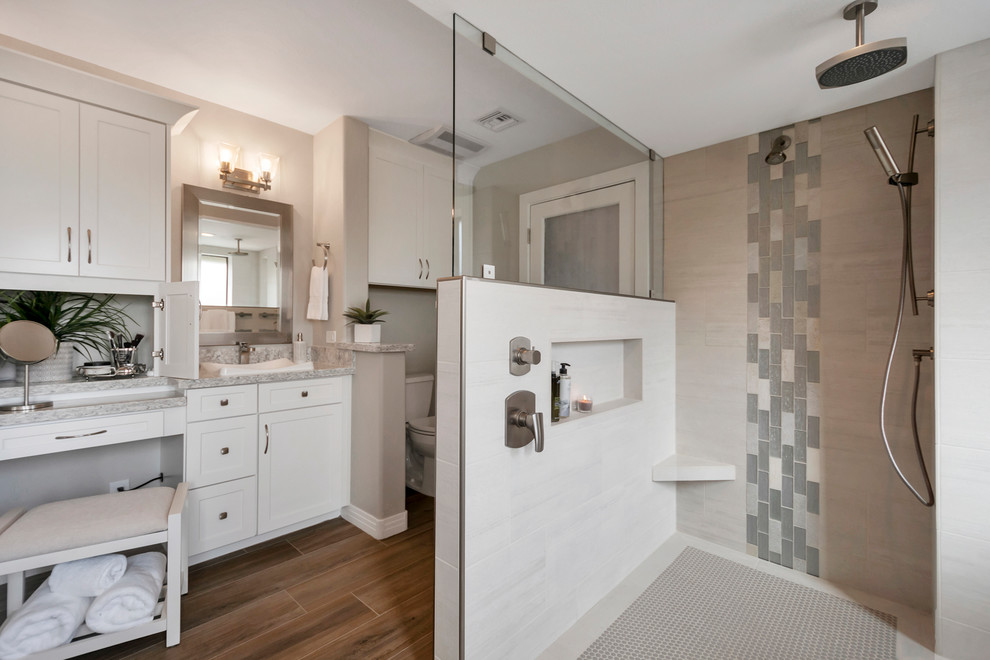 Inspiration for a large transitional master gray tile and porcelain tile porcelain tile and brown floor drop-in bathtub remodel in Phoenix with shaker cabinets, white cabinets, gray walls, a drop-in sink, quartz countertops and gray countertops