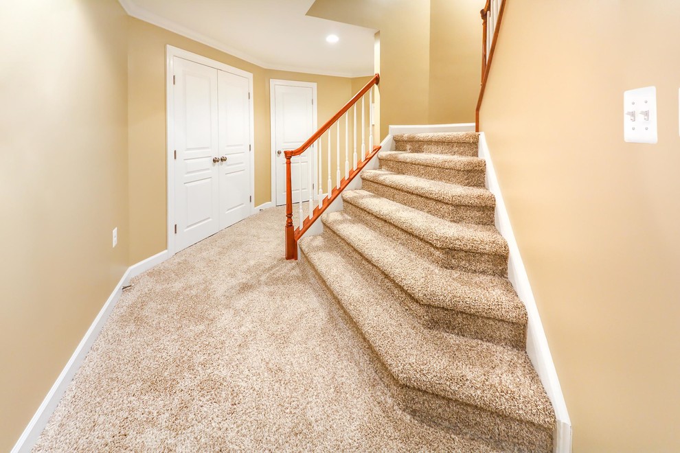 Design ideas for a medium sized traditional carpeted l-shaped wood railing staircase spindle in DC Metro with carpeted risers.