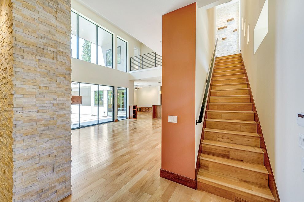 Photo of a mid-sized modern wood straight staircase in Dallas with wood risers.