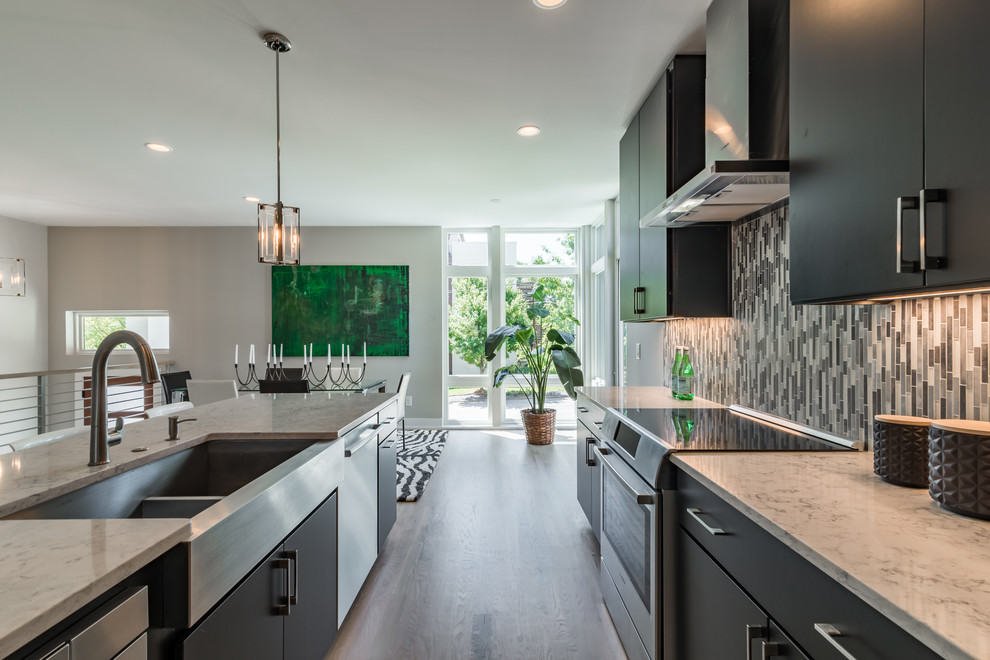 Design ideas for a mid-sized modern single-wall eat-in kitchen in Atlanta with a farmhouse sink, flat-panel cabinets, dark wood cabinets, quartzite benchtops, metallic splashback, metal splashback, stainless steel appliances, light hardwood floors and with island.