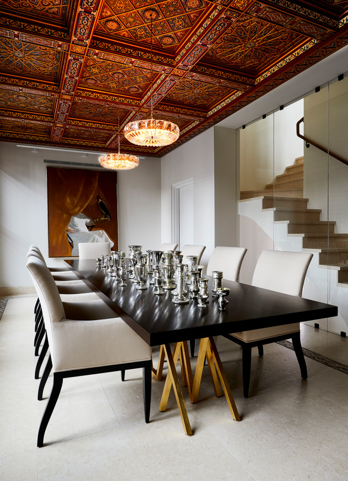 This is an example of a large bohemian open plan dining room in New York with white walls, travertine flooring, no fireplace, white floors and a drop ceiling.