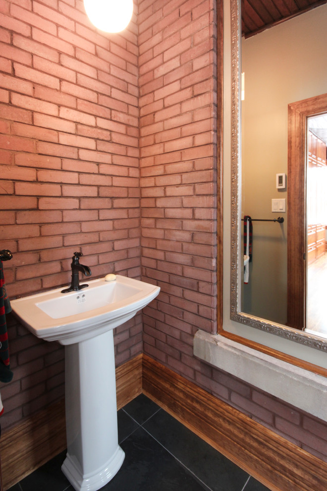 Photo of a mid-sized transitional powder room in Ottawa with a pedestal sink and slate floors.