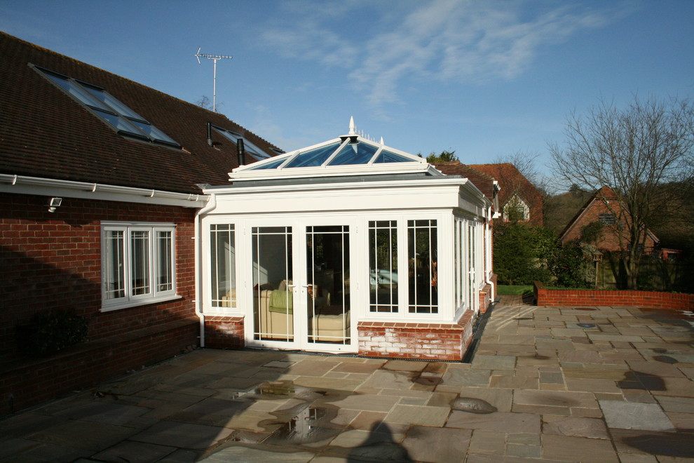 This is an example of an expansive traditional sunroom in Sussex with a skylight.