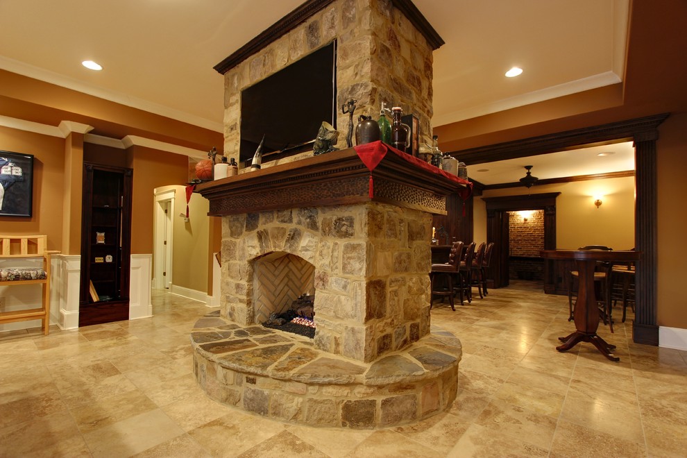 Inspiration for an expansive transitional walk-out basement in Atlanta with travertine floors, a standard fireplace, a stone fireplace surround and orange walls.