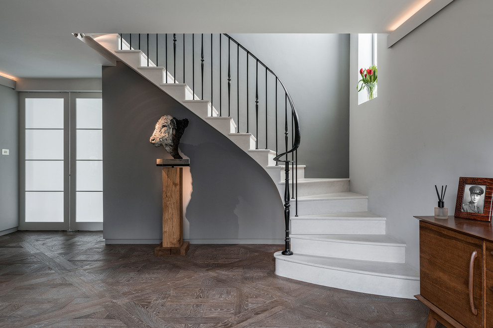 Inspiration for a mid-sized transitional curved staircase in Hampshire.