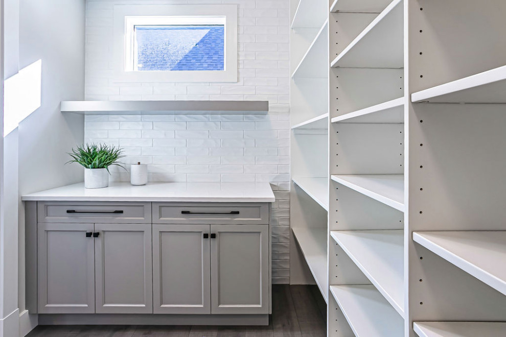 Transitional single-wall light wood floor and gray floor dry bar photo in Calgary with shaker cabinets, gray cabinets, quartz countertops, white backsplash, cement tile backsplash and white countertops