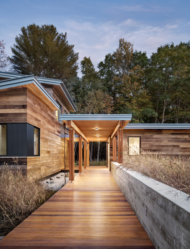 This is an example of a large contemporary one-storey brown house exterior in Portland Maine with wood siding.