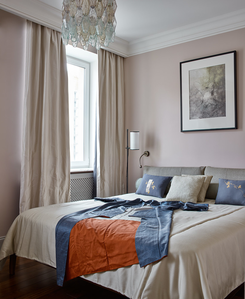 Small transitional master bedroom in Moscow with pink walls, dark hardwood floors and brown floor.
