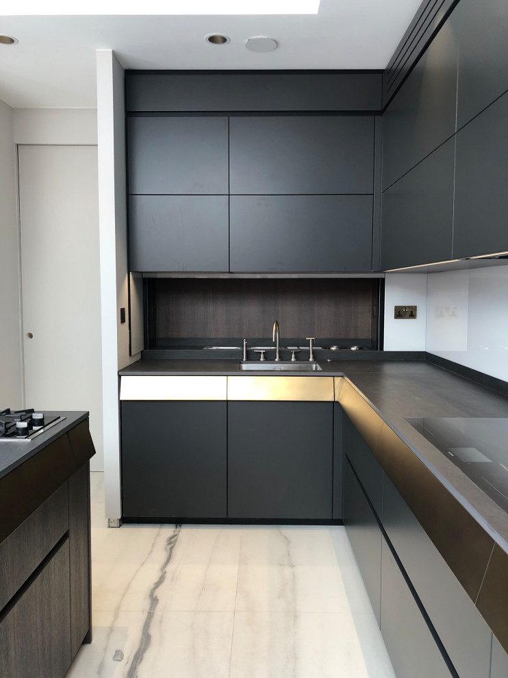 Design ideas for a large modern u-shaped eat-in kitchen in London with a drop-in sink, flat-panel cabinets, dark wood cabinets, concrete benchtops, white splashback, glass sheet splashback, black appliances, ceramic floors, with island, white floor, grey benchtop and recessed.